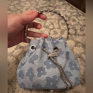 Brand new. Light blue bag with silver hardware. Top handle and chain.
